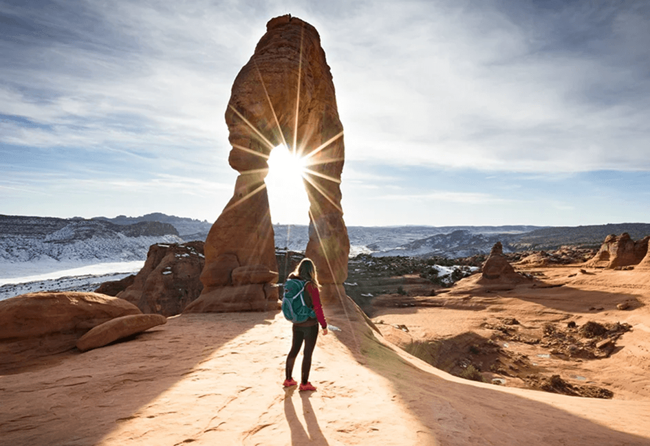 Traveler at rock arch